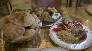 n this captivating slow-motion video, a table is adorned with delectable Egyptian food, showcasing a close-up view of the rich flavors and textures of Arabic cuisine.