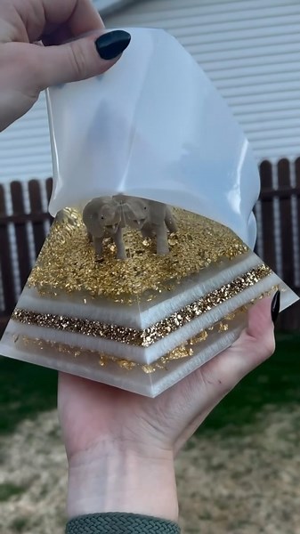 Art Viral 🎨 on Instagram: "Resin pyramids are mesmerizing artworks created by layering resin, which can be tinted or embedded with items such as flowers, crystals, or personal mementos. The process involves pouring resin into a pyramid mold in stages, allowing each layer to cure before adding the next, building depth and complexity. Artists often use materials like glitter, gold flakes, dried flowers, and crystals to produce unique and visually stunning effects. These pyramids serve not only as