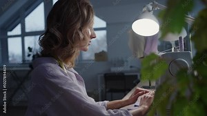 Fashion designer crafting garments with a sewing machine in a well-lit studio, highlighting dedication and precision in the intricate art of clothing creation and craftsmanship