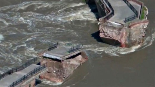 Historic bridge partially collapses into heavily flooded river in Spain