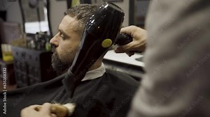 Barber Using Hair Dryer And Brush To Finish The Hair Styling - close up