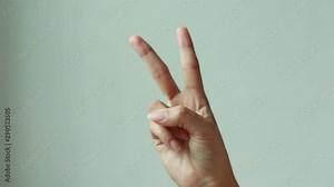Female one hand holding two fingers up in sign language.two fingers up and showing peace or victory symbol or letter V.