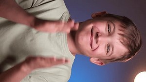 vertical video boy clapping his hands and smiling