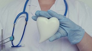female scientist, doctor holding heart model, microprocessor, microchip, biochip tweezers for immunocytochemical studies heart, treatment cardiovascular disease, experimental nanotechnology medicine