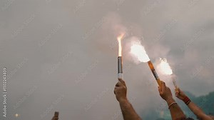 Colorful smoke bombs in action, representing pyrotechnics used for celebrations, sports fandom, social movements, political protests, revolutions, and dramatic visual effects in media production
