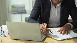 Businessman checks income and expenses from summary graph for accounting accuracy, business auditing concept, 4k close-up video