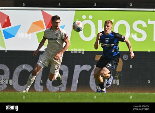 Paderborn, Germany. 21st Mar, 2026. Soccer, Men: Bundesliga 2, SC Paderborn 07 - Dynamo Dresden, Matchday 27, Home Deluxe Arena: Laurin Curda (r, SC Paderborn 07) fights for the ball with Alexander Rossipal (l, Dynamo Dresden). Credit: Swen Pförtner/dpa - IMPORTANT NOTE: In accordance with the regulations of the DFL German Football League and the DFB German Football Association, it is prohibited to utilize or have utilized photographs taken in the stadium and/or of the match in the form of seque