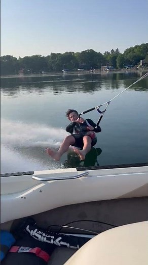 Person is barefoot waterskiing on a glass calm lake!