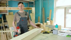 Stapling of wooden parts with a red pneumatic stapler. Furniture manufacture.