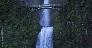 Waterfall Multnomah Falls 4K Aerial Drone - At bottom of falls fly under bridge from waterfall to the next