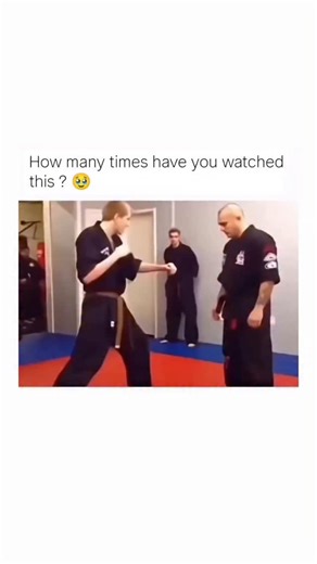 MEMES WORLD 🌎 on Instagram: "This video clip depicts a brief martial arts encounter on a matted floor, followed by a humorous audio overlay. The scene opens with two men in black gi uniforms facing each other in a training or demonstration setting, with two other observers in the background. The younger man on the left takes a ready stance, but is quickly and effectively countered by the older, bald man on the right, who executes a rapid takedown or sweep, causing the younger man to immediately