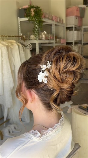 Soft and romantic twisted bridal updo featuring our beautiful Flora Clips! 🦢 . #bridalhair #weddinghair #bridalhairaccessories #updo