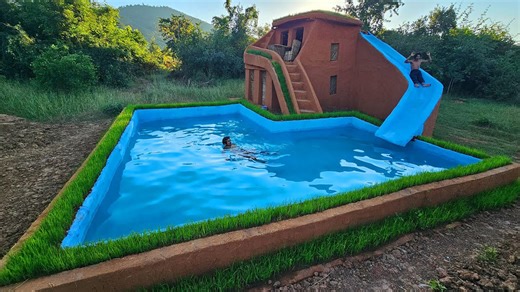 This hand-built pool and water slide look priceless beside luxury vacation resorts