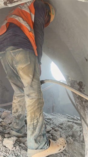 Worker Demolishes Concrete in Tight Tunnel Space