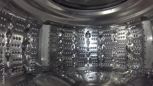 Washer, digital camera inside a rotating perforated drum. Internal view of a washing machine drum during washing process. Stock Video