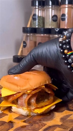 Bacon-Wrapped Cheeseburger Recipe Ingredients: • 1 pound ground beef • 9 slices bacon, divided • 4 slices of your favorite cheese • Burger buns • Mofo Delicious seasoning (or your preferred burger seasoning) • Optional toppings: lettuce, tomato, pickles, onions, ketchup, mustard Instructions: 1. Preheat Oven: Preheat your oven to 350°F (175°C). 2. Prepare the Burger Patties: 2. Divide the ground beef into two equal portions for two burgers. 2. Season each portion of ground beef generously with M