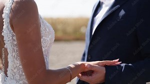 Hands of newlyweds during romantic photoshoot after the wedding ceremony. Bride and groom holding hands. Happy newlywed couple joined hands. Love, care and tenderness forever. Close-up.