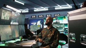 Military agent using augmented reality tech in control room, analyzing aerial reconnaissance data. Intelligence corps expert controlling drones attacking strategic targets using AR hologram, camera B