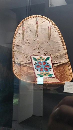 This Athabascan baby carrier is made from Birch bark, willow root, glass beads and moose hide. Mothers wear these traditionally, carrying the baby so that mom can have her hands free for berry picking etc... This baby basket was made by Margie Sparks, Athabascan. #ANHC #culturaltourism | Alaska Native Heritage Center