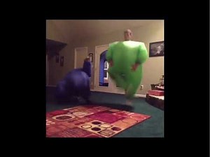 Two Men Dancing In Inflatable Costumes