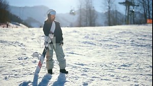 Winter sports and recreation, woman in snowboarding equipment standing on slope. Active pastime and rest in nature in Christmas holidays, extreme sport activities, female snowboarder in skiing resort