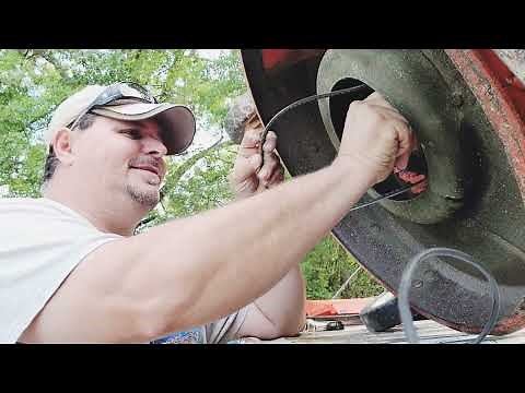 Working on an Ariens push mower changing the back belt for the drive.