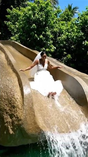 A wedding bride steps into a cliff slide adventure still in full bridal vibe 💍✨