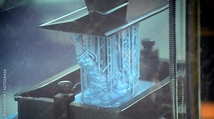 Working of photopolymer sla 3D printer. Platform with building object lowered into liquid photopolymer resins and hardened under ultraviolet laser. Progressive additive technology. 3D printer printing