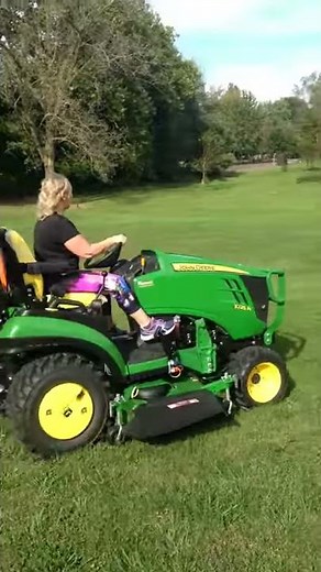 Angela driving our 1025R John Deere compact utility tractor