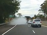 Car on highway shoots out cloud of smoke and then disappears