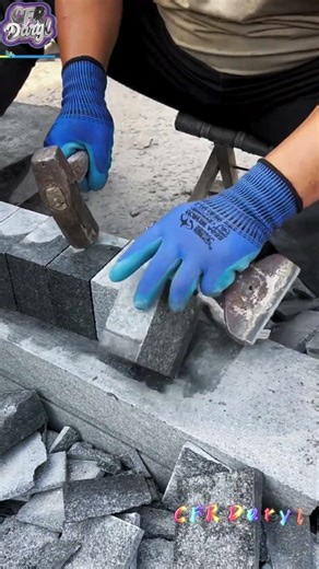 The stonemason chiseled thin granite with a chisel