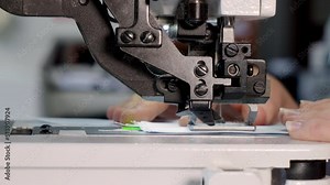 Sewing machine close up. You can clearly see how the needle works. Light industry. Sewing factory. woman working on a sewing machine. Tailoring