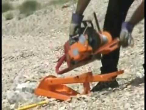 The Lewis Winch, a portable winch, uses the Ground Anchor to pull a large rock