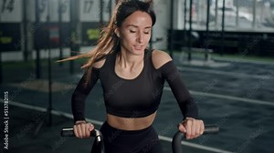 Young female athlete trains cardio on a bicycle with a fan, cardio and endurance training
