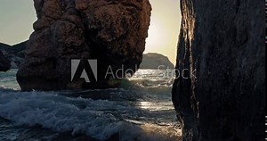 Background video of the nature landscape of the ocean with a rocky shore at sunrise. Waves of the ocean, tourism and weekends on the sea. High quality 4k footage