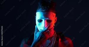 African man removing white face mask in ultraviolet light