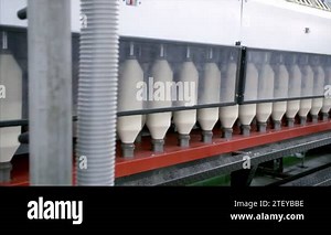 Textile plant in India - Large scale industry in India. Machine automation and advance technology. Closeup shot of textile spinning machine with white thread clews working in the manufacturing cloth industry Stock Video Footage - Alamy
