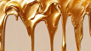 Golden paint drips slowly, highlighting its rich texture and fluid movement.