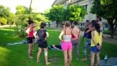 A group lesson on acroyoga master class which takes place on the lawn...