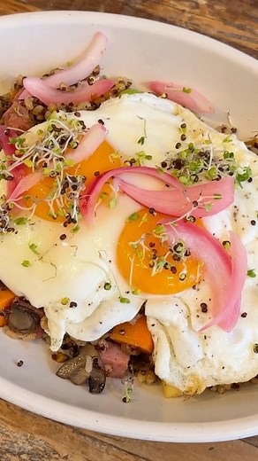 Behind the dish: With our signature spicy-sweet sauce, 100% grass-fed uncured Niman Ranch ham, and the crisp freshness of edamame. Pineapple and pickled onions bring tropical tang and are topped with a jammy Vital Farms pasture-raised egg. Link in bio to stop drooling and start eating. | True Food Kitchen