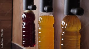 A bar counter with draft beer. Draft beer in plastic bottles. Three different types of beer are bottled in disposable bottles. Various beers on automatic bottling.