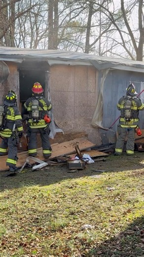 Firefighters doing overhaul at a Working Structure Fire