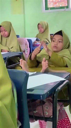 Child Counts Fingers and Toes in Math Class