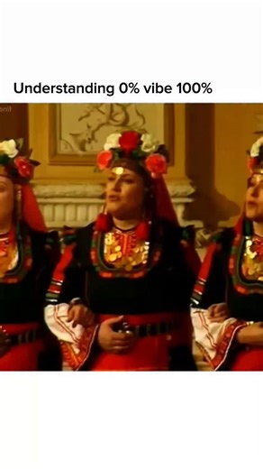 The Vibe on Instagram: "This video captures a high-energy performance of the traditional Bulgarian folk song "Bre Petrunko", a piece famous for its complex rhythmic patterns and powerful vocal harmonies. The footage features a female choir—likely the Koutev Bulgarian National Ensemble—dressed in traditional regional costumes with vibrant embroidery and floral headpieces. They are led by a spirited conductor whose intense energy matches the fast-paced, "open-throated" singing style typical of the