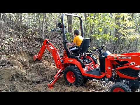 Kubota BX25 backhoe digging.