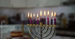 Judaism tradition family religious holiday symbols lighting hanukkiah menorah candles during Hanukkah celebration