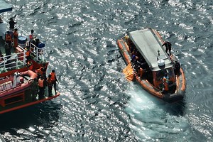 Rescuers search wreckage after football coach dies in Indonesian tour boat sinking