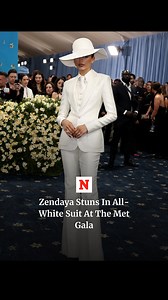 Actress Zendaya arrived at the 2025 Met Gala, looking stunning in an all-white suit complete with a white broad-brimmed hat that nearly entirely covered her face. | Newsweek