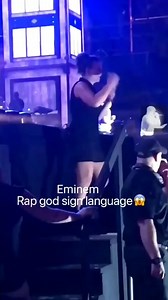 A woman doing "rap god" in sign language