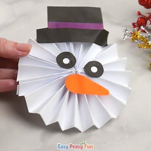 Snowman Craft from Paper Rosette https://www.easypeasyandfun.com/paper-rosette-snowman-craft/ | Easy Peasy and Fun